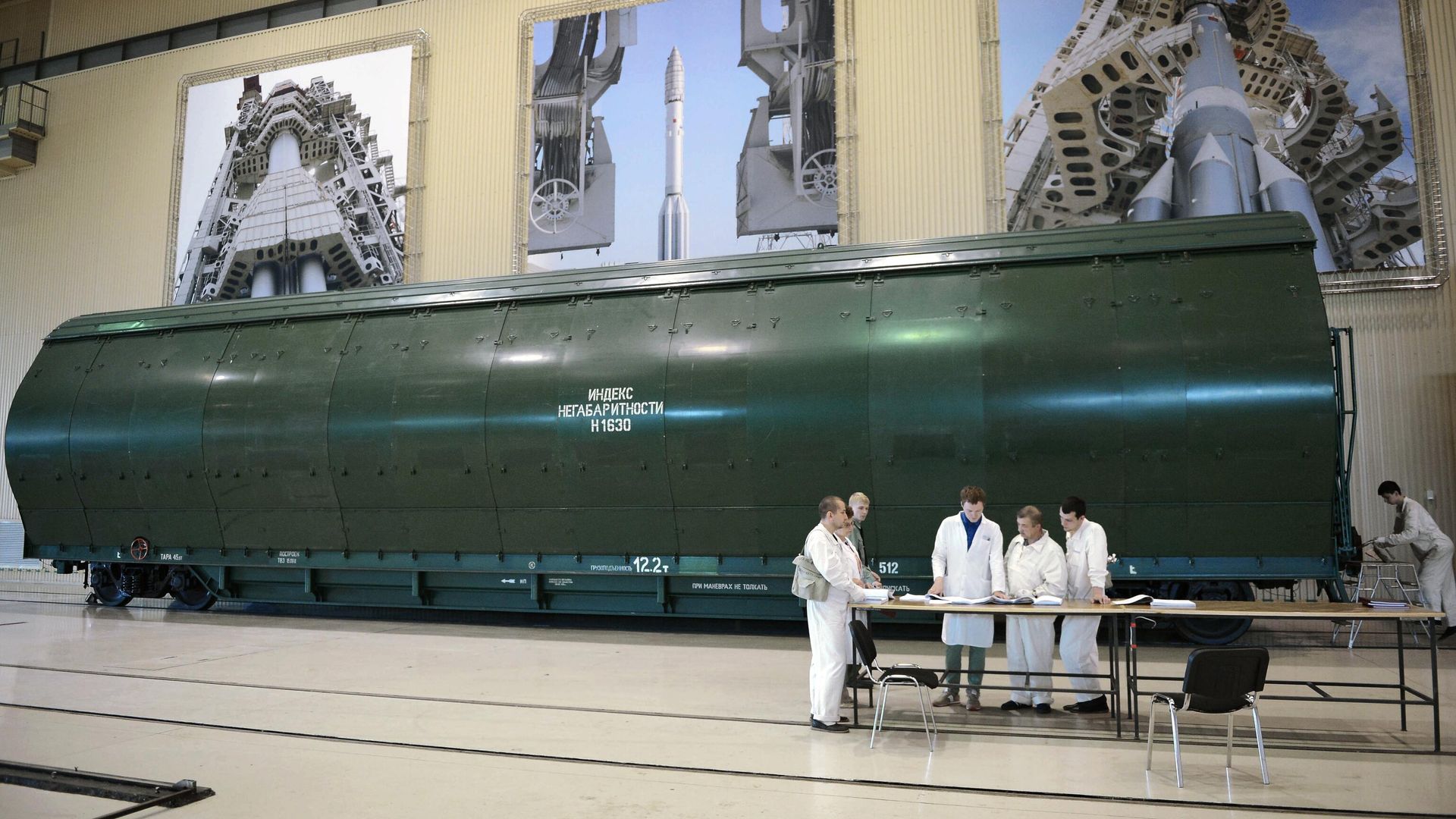 Сотрудники государственного космического научно-производственного центра имени М.В. Хруничева у транспортного контейнера с блоками ракеты Ангара А5 в одном из цехов предприятия в Москве Сотрудники государственного космического научно-производственного центра имени М.В. Хруничева у транспортного контейнера с блоками ракеты Ангара А5 в одном из цехов предприятия в Москве - РИА Новости, 1920, 30.07.2021