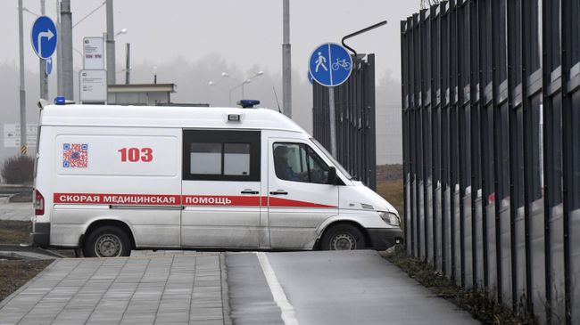 Машина скорой помощи заезжает на территорию больничного комплекса