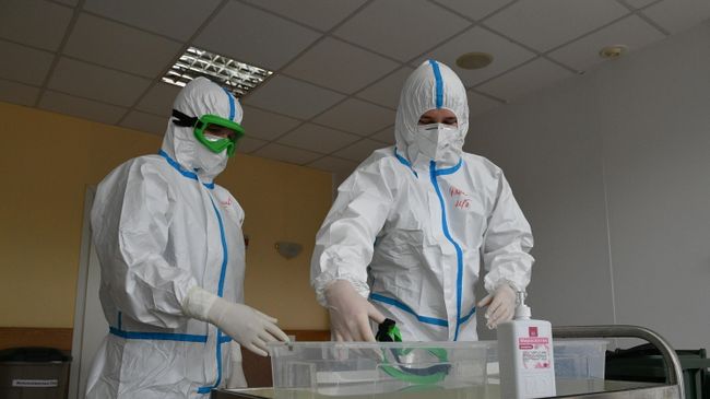 Медицинские работники в защитных костюмах