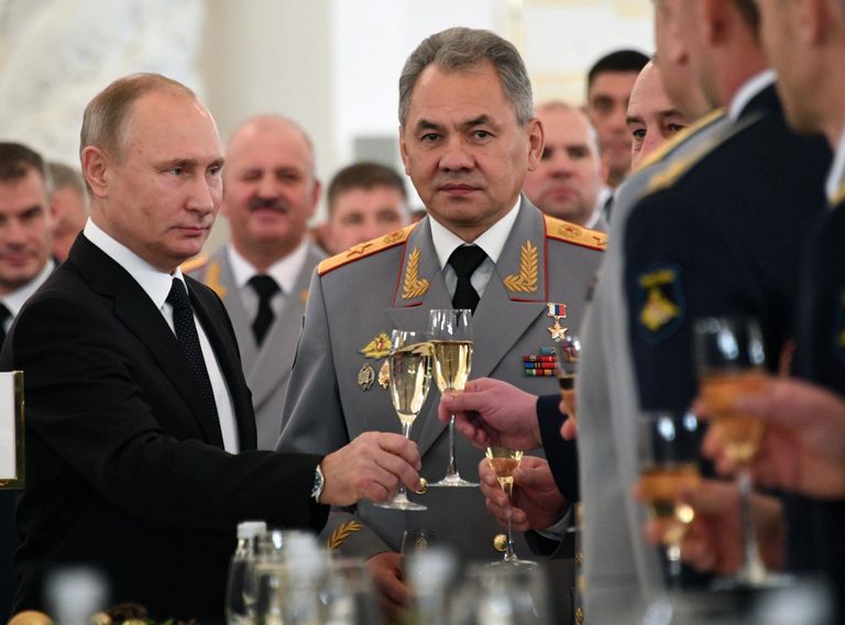 Президент РФ Владимир Путин и министр обороны РФ Сергей Шойгу (в центре) во время встречи с военнослужащими Вооруженных сил РФ, принимавшими участие в антитеррористической операции в Сирийской Арабской Республике