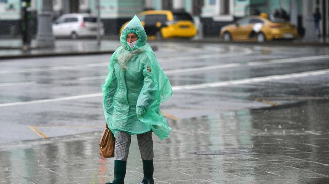 Женщина во время дождя на площади Белорусского вокзала в Москве Женщина во время дождя на площади Белорусского вокзала в Москве