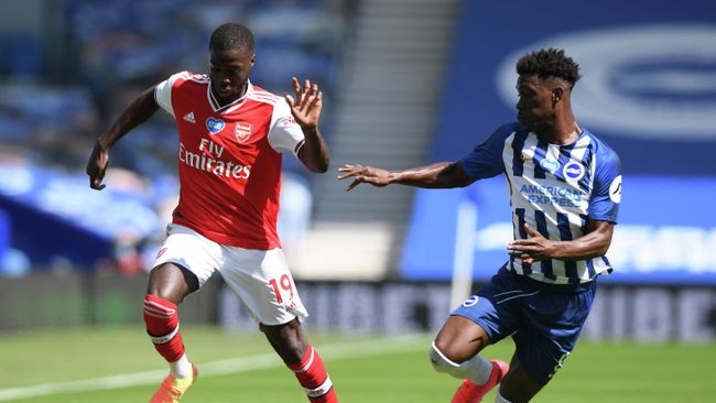 Arsenal's French-born Ivorian midfielder Nicolas Pepe (L) and Brighton's Ivorian midfielder Yves Bissouma compete during the English Premier League football match between Brighton and Hove Albion and Arsenal at the American Express Community Stadium in Brighton, southern England on June 20, 2020. (Photo by Mike Hewitt / POOL / AFP) / RESTRICTED TO EDITORIAL USE. No use with unauthorized audio, video, data, fixture lists, club/league logos or 'live' services. Online in-match use limited to 120 images. An additional 40 images may be used in extra time. No video emulation. Social media in-match use limited to 120 images. An additional 40 images may be used in extra time. No use in betting publications, games or single club/league/player publications. / Arsenal's French-born Ivorian midfielder Nicolas Pepe (L) and Brighton's Ivorian midfielder Yves Bissouma compete during the English Premier League football match between Brighton and Hove Albion and Arsenal at the American Express Community Stadium in Brighton, southern England on June 20, 2020. (Photo by Mike Hewitt / POOL / AFP) / RESTRICTED TO EDITORIAL USE. No use with unauthorized audio, video, data, fixture lists, club/league logos or 'live' services. Online in-match use limited to 120 images. An additional 40 images may be used in extra time. No video emulation. Social media in-match use limited to 120 images. An additional 40 images may be used in extra time. No use in betting publications, games or single club/league/player publications. /