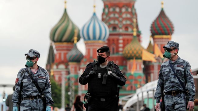 Сотрудники полиции в защитных масках на Красной Площади в Москве Сотрудники полиции в защитных масках на Красной Площади в Москве
