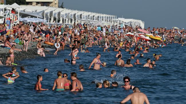 Отдыхающие на пляже Имеретинской низменности в Адлерском районе города Сочи Отдыхающие на пляже Имеретинской низменности в Адлерском районе города Сочи