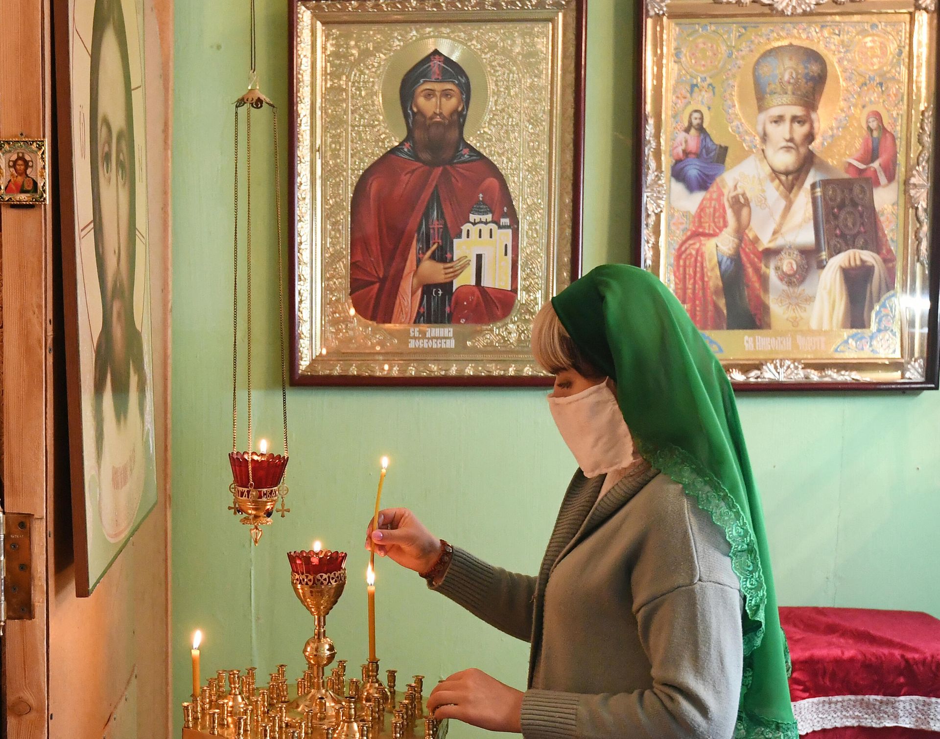 Верующая в медицинской маске во время Божественной литургии в день Лазаревой субботы в православном Храме Святаго Князя Даниила Московского в селе Бартат Красноярского кра Верующая в медицинской маске во время Божественной литургии в день Лазаревой субботы в православном Храме Святаго Князя Даниила Московского в селе Бартат Красноярского кра - РИА Новости, 1920, 28.10.2020