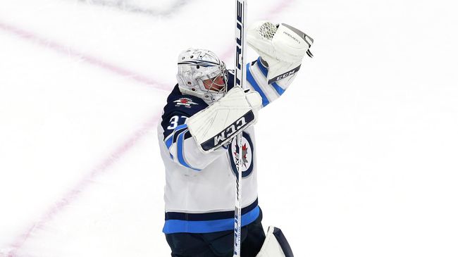 EDMONTON, ALBERTA - AUGUST 03: Connor Hellebuyck #37 of the Winnipeg Jets celebrates the win over the Calgary Flames during Game Two of the Western Conference Qualification Round prior to the 2020 NHL Stanley Cup Playoffs at Rogers Place on August 03, 2020 in Edmonton, Alberta. The Winnipeg Jets defeated the Calgary Flames 3-2.   Jeff Vinnick/Getty Images/AFP