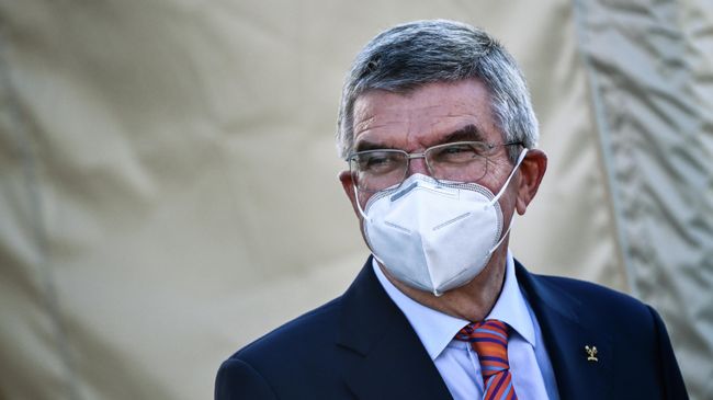 IOC President Thomas Bach looks on during the podium ceremonies following  the Women's Elite Road Race, a 143-kilometer route around Imola, Emilia-Romagna, Italy, on September 26, 2020 as part of the UCI 2020 Road World Championships. (Photo by Marco BERTORELLO / AFP)