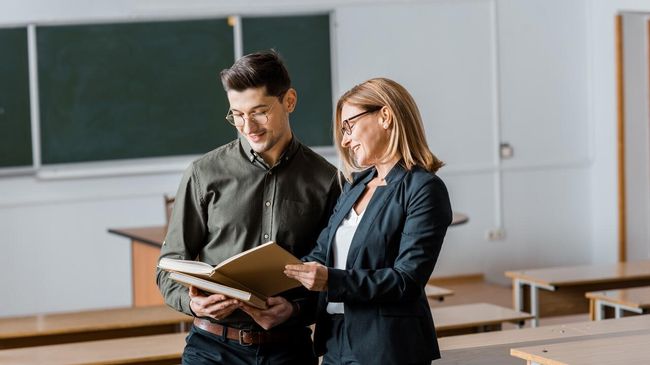 Преподаватель и студент в аудитории университета Преподаватель и студент в аудитории университета