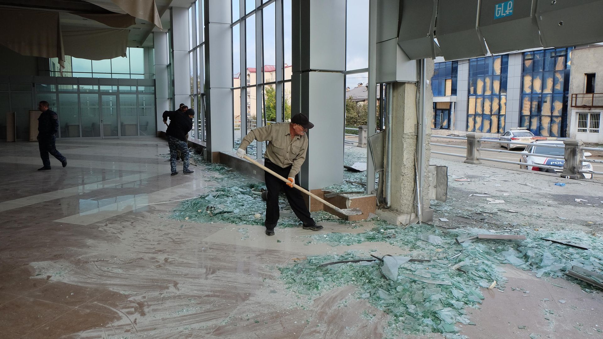 Мужчины убирают разбитые стекла в центре Степанакерта Мужчины убирают разбитые стекла в центре Степанакерта - РИА Новости, 1920, 16.11.2020