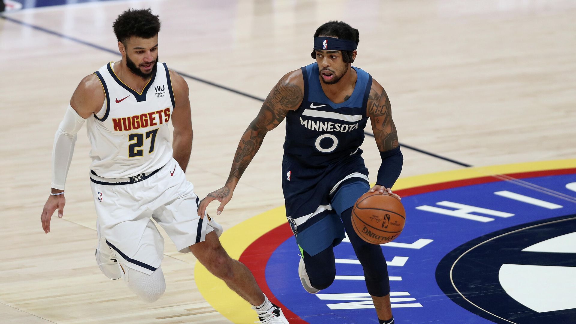 DENVER, COLORADO - JANUARY 05: D'Angelo Russell #0 of the Minnesota Timberwolves drives against Jamal Murray #27 of the Denver Nuggets in the third quarter at Ball Arena on January 05, 2021 in Denver, Colorado. NOTE TO USER: User expressly acknowledges and agrees that, by downloading and or using this photograph, User is consenting to the terms and conditions of the Getty Images License Agreement. Matthew Stockman/Getty Images/AFP DENVER, COLORADO - JANUARY 05: D'Angelo Russell #0 of the Minnesota Timberwolves drives against Jamal Murray #27 of the Denver Nuggets in the third quarter at Ball Arena on January 05, 2021 in Denver, Colorado. NOTE TO USER: User expressly acknowledges and agrees that, by downloading and or using this photograph, User is consenting to the terms and conditions of the Getty Images License Agreement. Matthew Stockman/Getty Images/AFP - РИА Новости, 1920, 06.01.2021