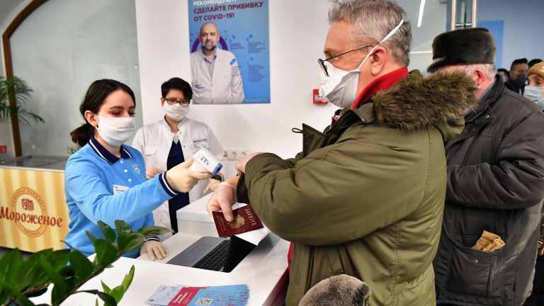 Измерение температуры при входе в пункт вакцинации от коронавируса в ГУМе в Москве Измерение температуры при входе в пункт вакцинации от коронавируса в ГУМе в Москве