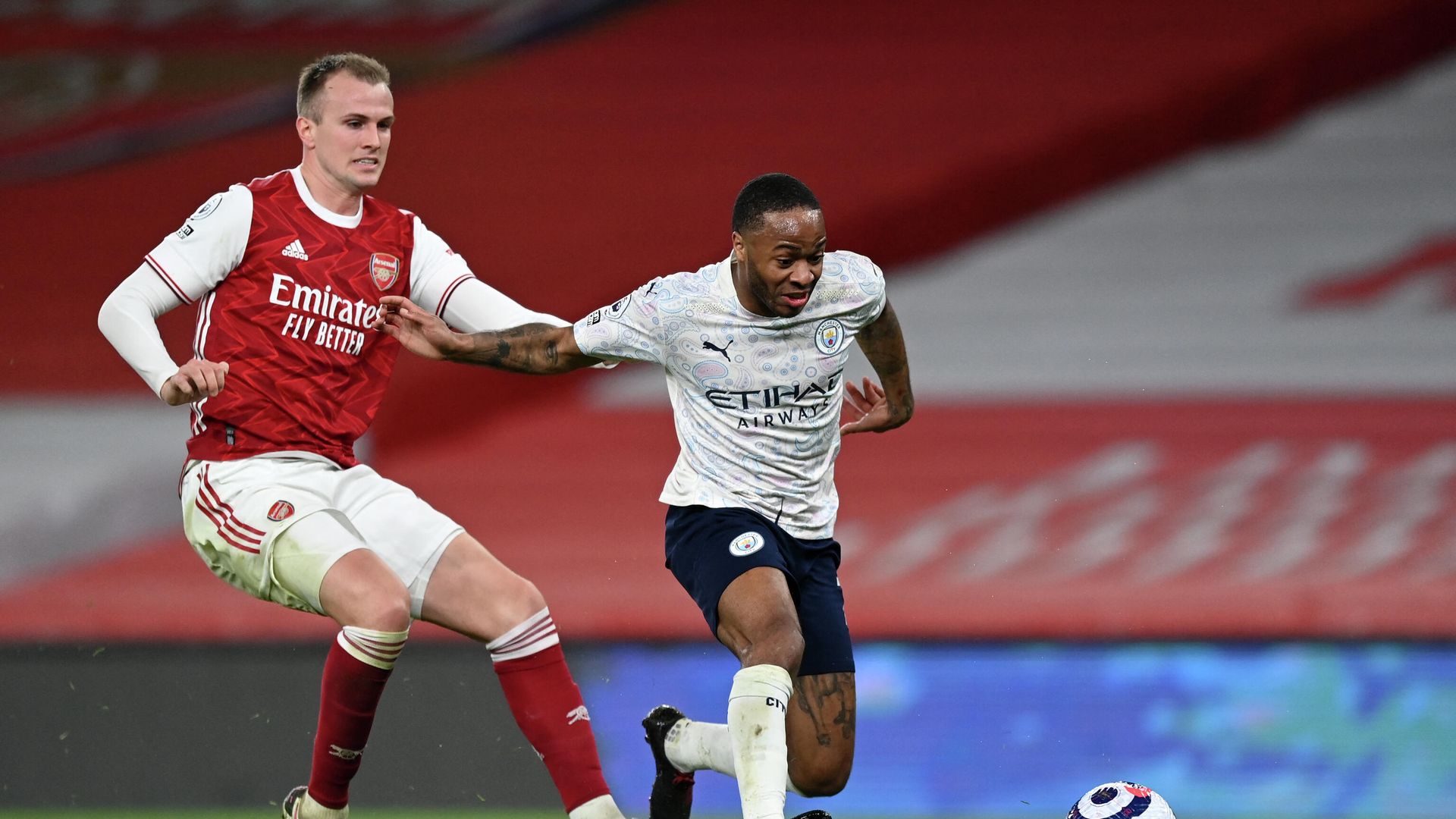 Arsenal's English defender Rob Holding (L) vies with Manchester City's English midfielder Raheem Sterling (R) during the English Premier League football match between Arsenal and Manchester City at the Emirates Stadium in London on February 21, 2021. (Photo by Shaun Botterill / POOL / AFP) / RESTRICTED TO EDITORIAL USE. No use with unauthorized audio, video, data, fixture lists, club/league logos or 'live' services. Online in-match use limited to 120 images. An additional 40 images may be used in extra time. No video emulation. Social media in-match use limited to 120 images. An additional 40 images may be used in extra time. No use in betting publications, games or single club/league/player publications. / Arsenal's English defender Rob Holding (L) vies with Manchester City's English midfielder Raheem Sterling (R) during the English Premier League football match between Arsenal and Manchester City at the Emirates Stadium in London on February 21, 2021. (Photo by Shaun Botterill / POOL / AFP) / RESTRICTED TO EDITORIAL USE. No use with unauthorized audio, video, data, fixture lists, club/league logos or 'live' services. Online in-match use limited to 120 images. An additional 40 images may be used in extra time. No video emulation. Social media in-match use limited to 120 images. An additional 40 images may be used in extra time. No use in betting publications, games or single club/league/player publications. / - РИА Новости, 1920, 21.02.2021