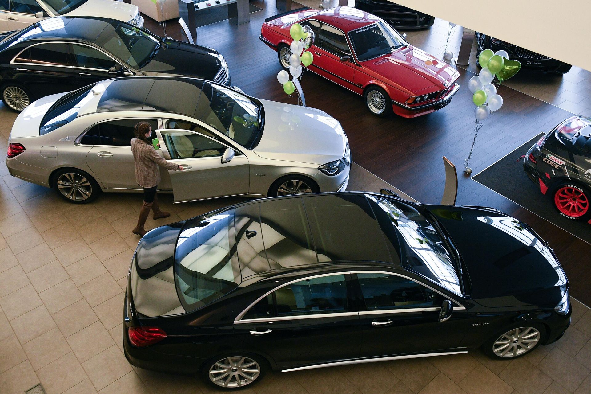 Менеджер демонстрирует покупателям автомобиль в автосалоне по продаже подержанных авто в Москве Менеджер демонстрирует покупателям автомобиль в автосалоне по продаже подержанных авто в Москве - РИА Новости, 1920, 06.05.2022