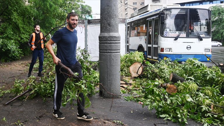 Мужчины убирают ветви деревьев после сильного ливня в Ростове-на-Дону Мужчины убирают ветви деревьев после сильного ливня в Ростове-на-Дону