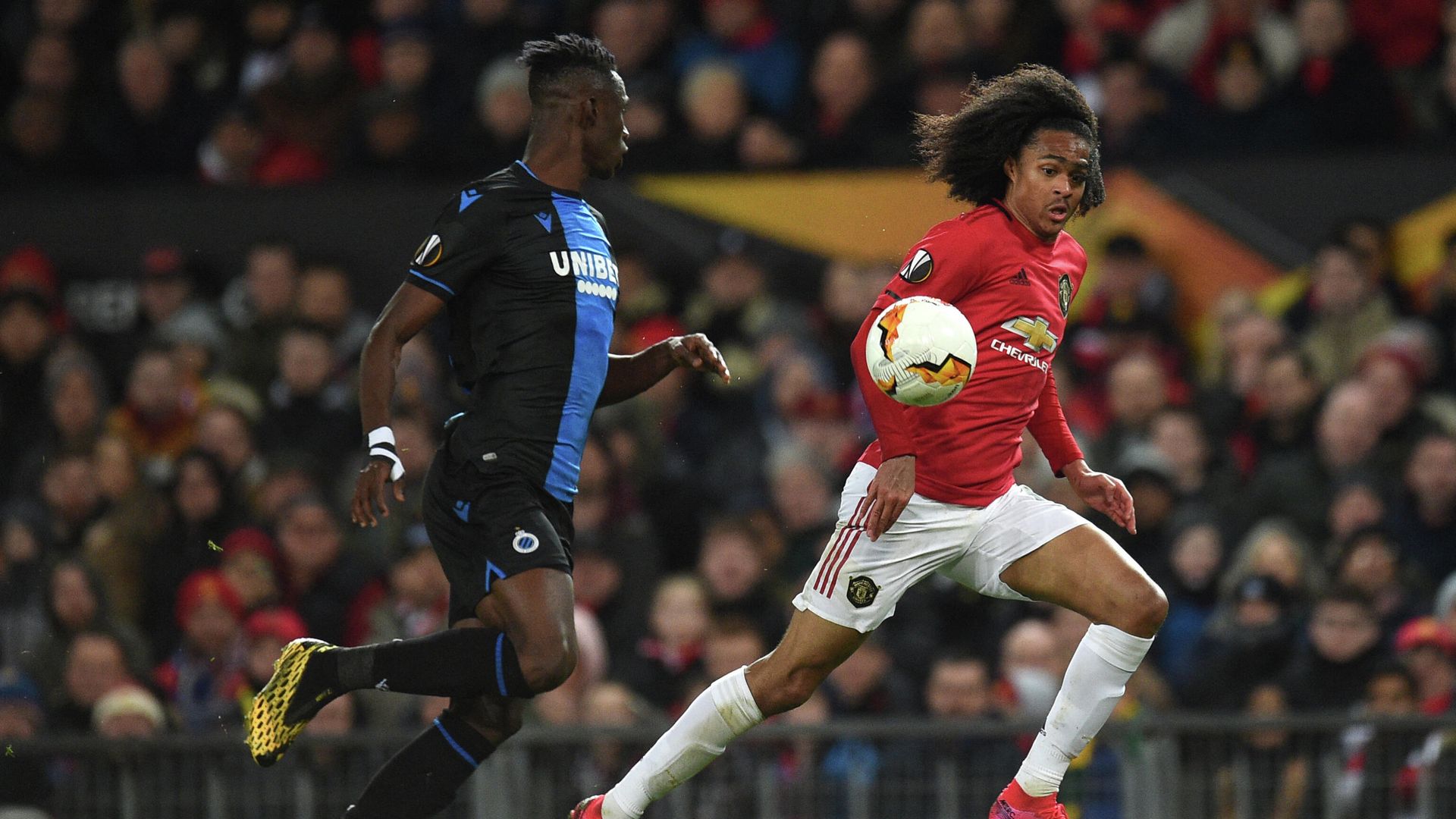 Club Brugge's Ivorian defender Odilon Kossounou (L) vies with Manchester United's Dutch midfielder Tahith Chong during the UEFA Europa League round of 32 second leg football match between Manchester United and Club Brugge at Old Trafford in Manchester, north west England, on February 27, 2020. (Photo by Oli SCARFF / AFP) Club Brugge's Ivorian defender Odilon Kossounou (L) vies with Manchester United's Dutch midfielder Tahith Chong during the UEFA Europa League round of 32 second leg football match between Manchester United and Club Brugge at Old Trafford in Manchester, north west England, on February 27, 2020. (Photo by Oli SCARFF / AFP) - РИА Новости, 1920, 09.07.2021