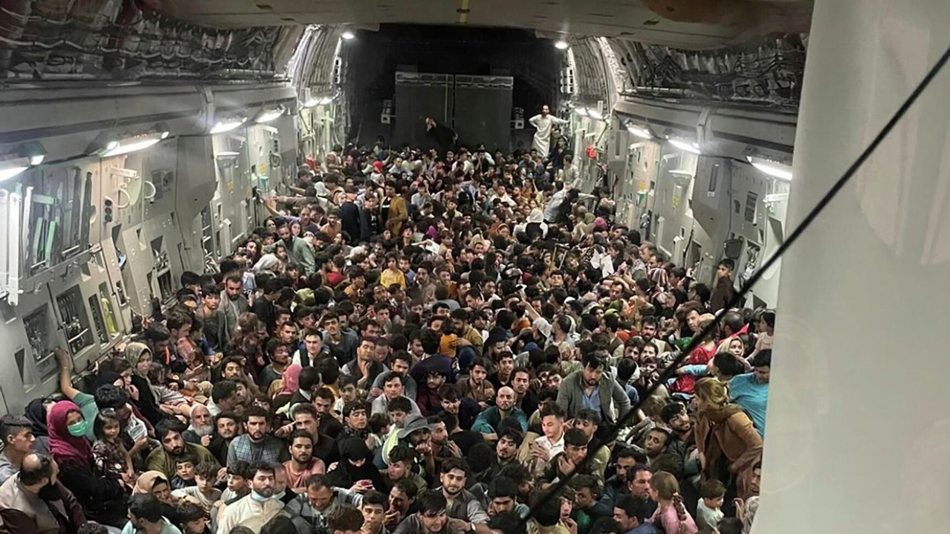 Люди внутри транспортного самолета C-17 Globemaster III ВВС США, перевозящего около 640 афганцев в Катар из Кабула, Афганистан, 15 августа 2021 Люди внутри транспортного самолета C-17 Globemaster III ВВС США, перевозящего около 640 афганцев в Катар из Кабула, Афганистан, 15 августа 2021 - РИА Новости, 1920, 17.08.2021