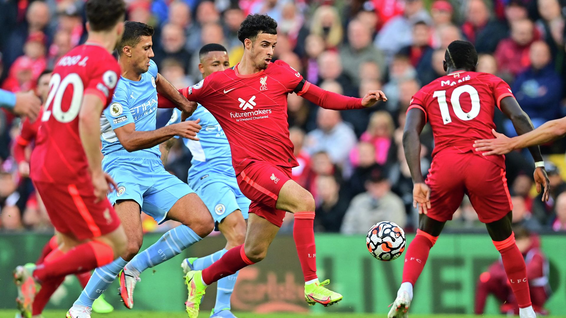 Manchester City's Spanish midfielder Rodrigo challenges Liverpool's English midfielder Curtis Jones (C) during the English Premier League football match between Liverpool and Manchester City at Anfield in Liverpool, northwest England, on October 3, 2021. (Photo by Paul ELLIS / AFP) / RESTRICTED TO EDITORIAL USE. No use with unauthorized audio, video, data, fixture lists, club/league logos or 'live' services. Online in-match use limited to 120 images. An additional 40 images may be used in extra time. No video emulation. Social media in-match use limited to 120 images. An additional 40 images may be used in extra time. No use in betting publications, games or single club/league/player publications. / Manchester City's Spanish midfielder Rodrigo challenges Liverpool's English midfielder Curtis Jones (C) during the English Premier League football match between Liverpool and Manchester City at Anfield in Liverpool, northwest England, on October 3, 2021. (Photo by Paul ELLIS / AFP) / RESTRICTED TO EDITORIAL USE. No use with unauthorized audio, video, data, fixture lists, club/league logos or 'live' services. Online in-match use limited to 120 images. An additional 40 images may be used in extra time. No video emulation. Social media in-match use limited to 120 images. An additional 40 images may be used in extra time. No use in betting publications, games or single club/league/player publications. / - РИА Новости, 1920, 03.10.2021