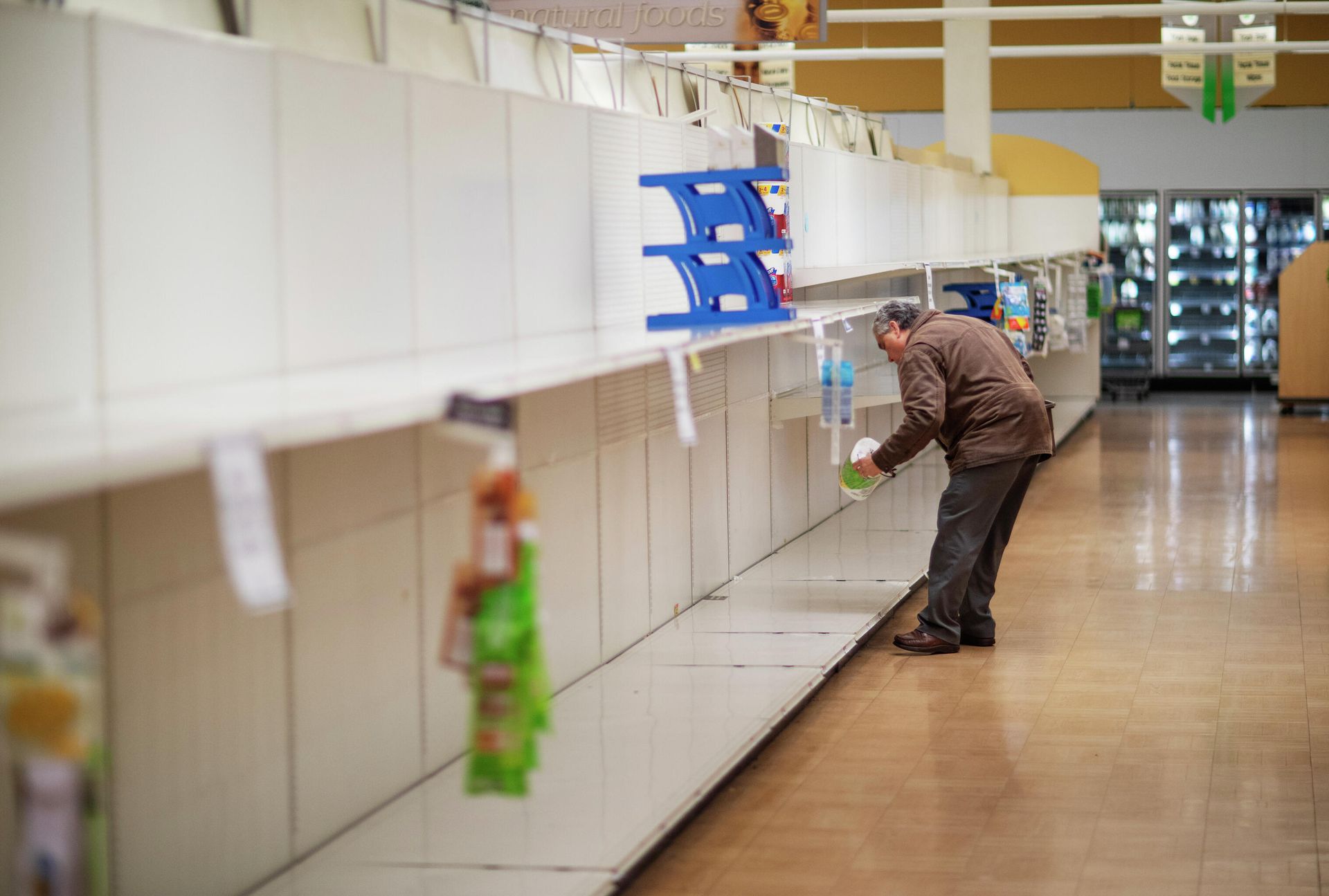 Мужчина берет с пустой полки пачку туалетной бумаги в супермаркете в Род-Айленд. Мужчина берет с пустой полки пачку туалетной бумаги в супермаркете в Род-Айленд. - РИА Новости, 1920, 05.10.2021