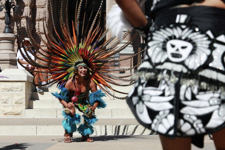 Участники танцевальной группы Danza Azteca Guadalupana выступают на мероприятии, посвященном Дню коренных народов, в Остине Участники танцевальной группы Danza Azteca Guadalupana выступают на мероприятии, посвященном Дню коренных народов, в Остине