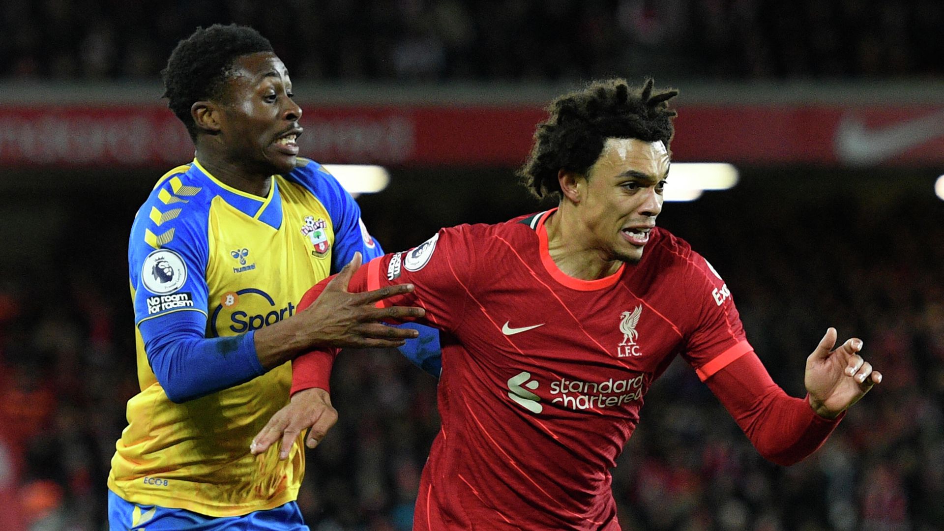 Southampton's English midfielder Nathan Tella (L) vies with Liverpool's English defender Trent Alexander-Arnold during the English Premier League football match between Liverpool and Southampton at Anfield in Liverpool, north west England on November 27, 2021. (Photo by Oli SCARFF / AFP) / RESTRICTED TO EDITORIAL USE. No use with unauthorized audio, video, data, fixture lists, club/league logos or 'live' services. Online in-match use limited to 120 images. An additional 40 images may be used in extra time. No video emulation. Social media in-match use limited to 120 images. An additional 40 images may be used in extra time. No use in betting publications, games or single club/league/player publications. / Southampton's English midfielder Nathan Tella (L) vies with Liverpool's English defender Trent Alexander-Arnold during the English Premier League football match between Liverpool and Southampton at Anfield in Liverpool, north west England on November 27, 2021. (Photo by Oli SCARFF / AFP) / RESTRICTED TO EDITORIAL USE. No use with unauthorized audio, video, data, fixture lists, club/league logos or 'live' services. Online in-match use limited to 120 images. An additional 40 images may be used in extra time. No video emulation. Social media in-match use limited to 120 images. An additional 40 images may be used in extra time. No use in betting publications, games or single club/league/player publications. / - РИА Новости, 1920, 27.11.2021