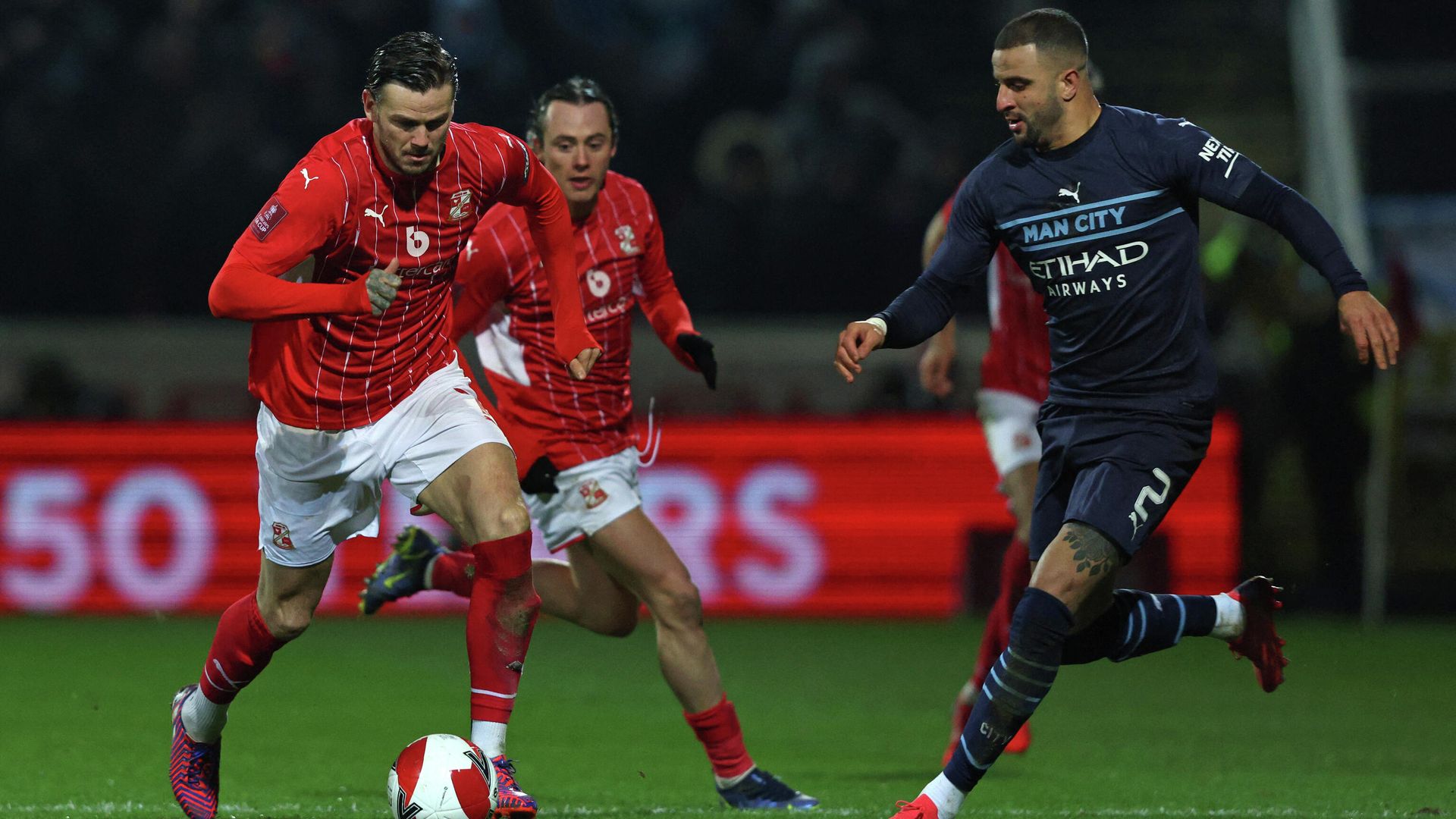 Manchester City's English defender Kyle Walker (R) vies with Swindon Town's English midfielder Ben Gladwin (L) during the English FA Cup third round football match between Swindon Town and Manchester City at County Ground, Swindon in western England on January 7, 2022. (Photo by Adrian DENNIS / AFP) / RESTRICTED TO EDITORIAL USE. No use with unauthorized audio, video, data, fixture lists, club/league logos or 'live' services. Online in-match use limited to 120 images. An additional 40 images may be used in extra time. No video emulation. Social media in-match use limited to 120 images. An additional 40 images may be used in extra time. No use in betting publications, games or single club/league/player publications. / Manchester City's English defender Kyle Walker (R) vies with Swindon Town's English midfielder Ben Gladwin (L) during the English FA Cup third round football match between Swindon Town and Manchester City at County Ground, Swindon in western England on January 7, 2022. (Photo by Adrian DENNIS / AFP) / RESTRICTED TO EDITORIAL USE. No use with unauthorized audio, video, data, fixture lists, club/league logos or 'live' services. Online in-match use limited to 120 images. An additional 40 images may be used in extra time. No video emulation. Social media in-match use limited to 120 images. An additional 40 images may be used in extra time. No use in betting publications, games or single club/league/player publications. / - РИА Новости, 1920, 08.01.2022