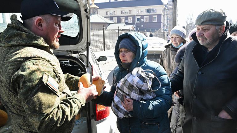 Жители Мариуполя стоят в очереди за гуманитарной помощью от волонтеров Жители Мариуполя стоят в очереди за гуманитарной помощью от волонтеров