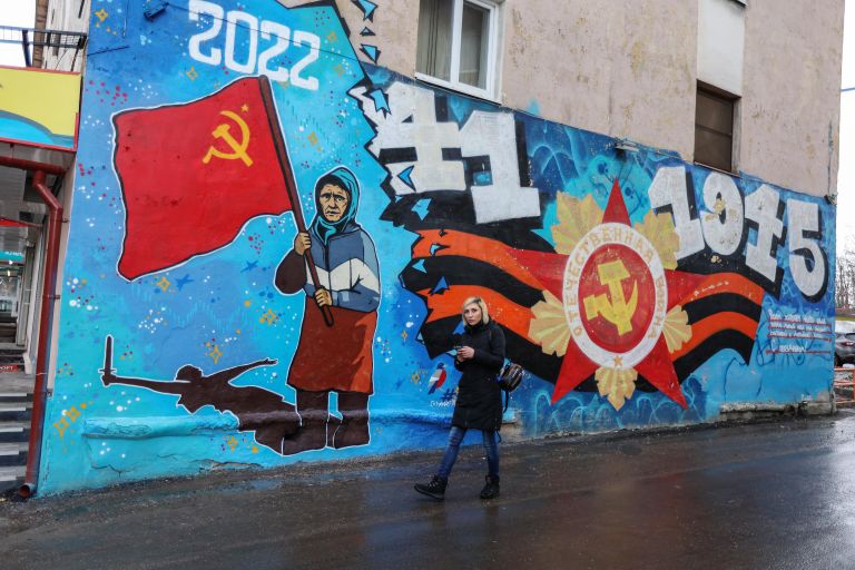 Граффити с изображением бабушки с красным флагом на фасаде здания в Мурманске Граффити с изображением бабушки с красным флагом на фасаде здания в Мурманске