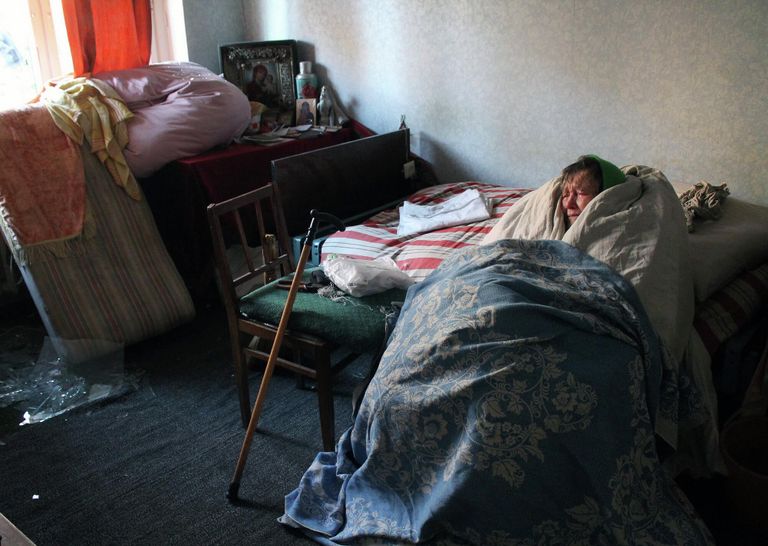 Жительница дома, поврежденного в результате обстрелов, в Киевском районе Донецка. Жительница дома, поврежденного в результате обстрелов, в Киевском районе Донецка.