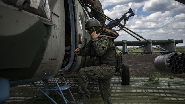 Военнослужащий у вертолета Ми-8МТВ на полевом аэродроме Военнослужащий у вертолета Ми-8МТВ на полевом аэродроме