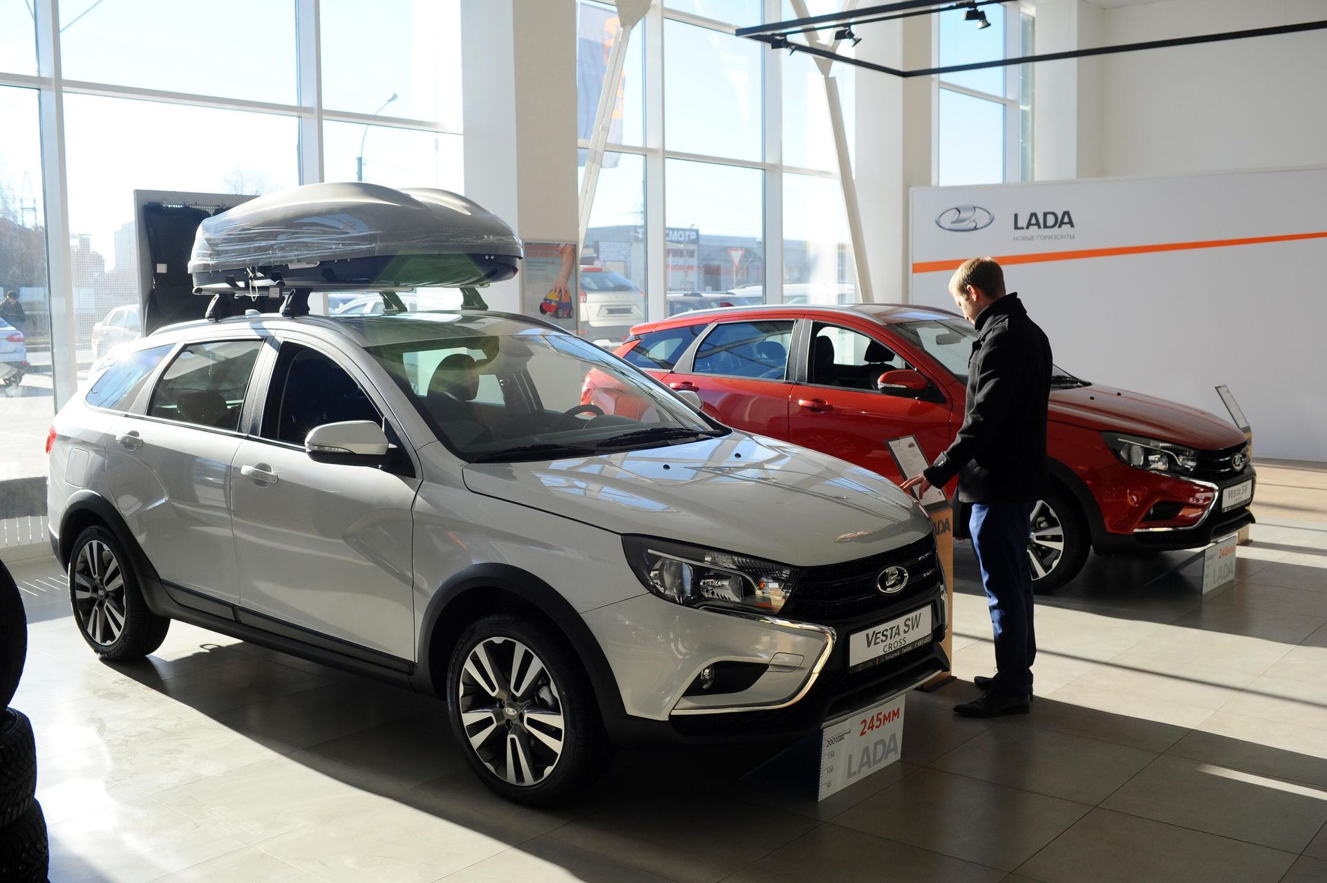 Посетитель рассматривает автомобиль Lada Vesta SW в демонстрационном зале автоцентра Западный в Тамбове Посетитель рассматривает автомобиль Lada Vesta SW в демонстрационном зале автоцентра Западный в Тамбове - РИА Новости, 1920, 16.09.2022
