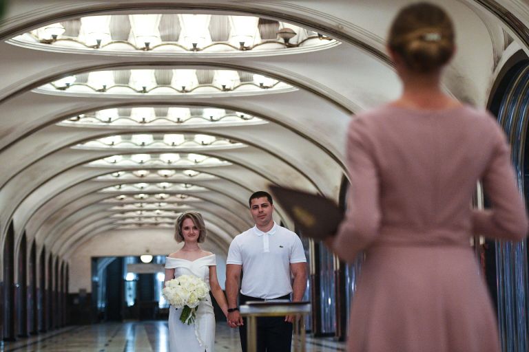 Пара молодоженов во время торжественной церемонии бракосочетания на станции Маяковская Московского метрополитена Пара молодоженов во время торжественной церемонии бракосочетания на станции Маяковская Московского метрополитена