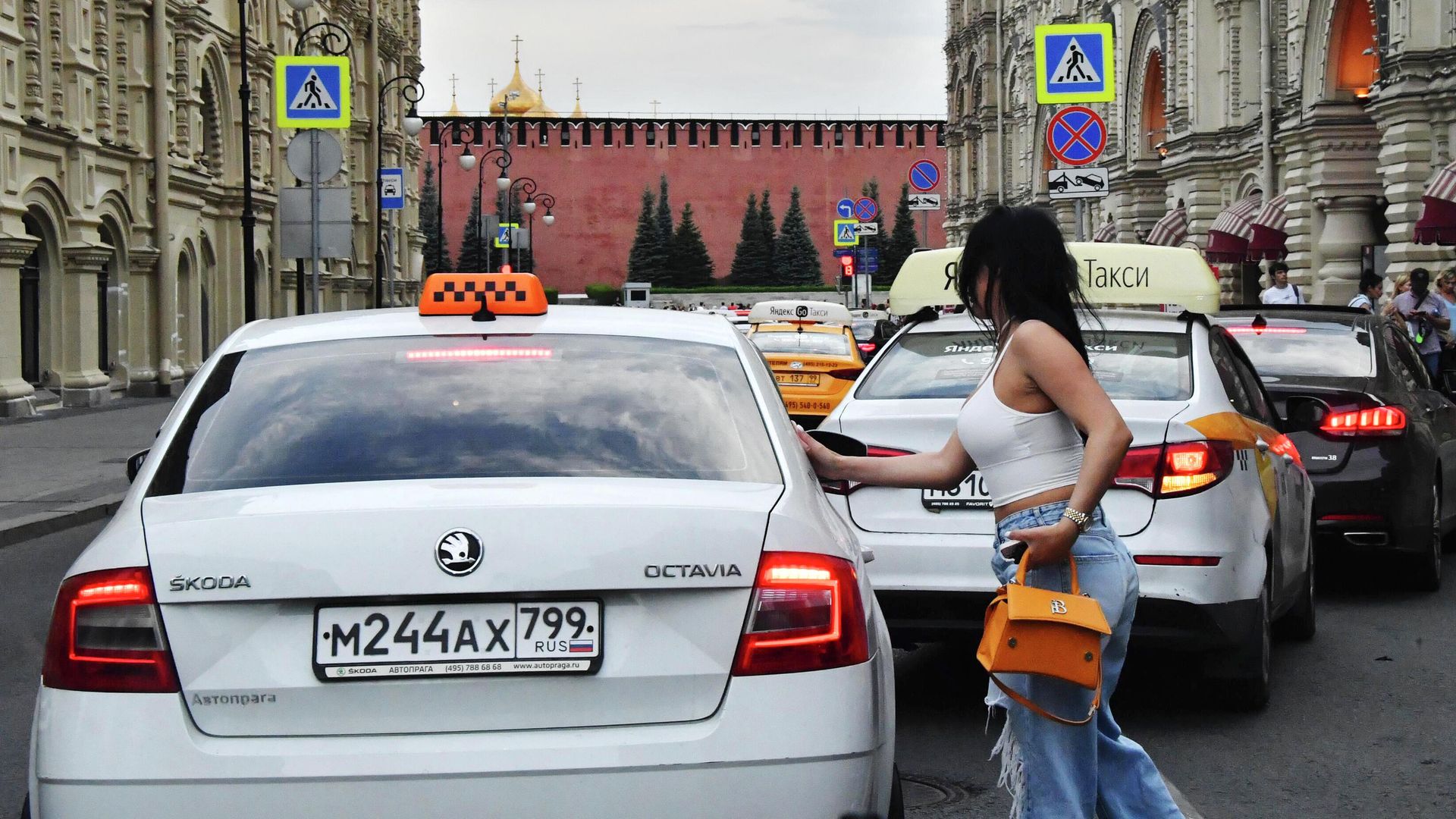 Девушка у машины такси на улице Ильинке в Москве Девушка у машины такси на улице Ильинке в Москве - РИА Новости, 1920, 09.08.2023