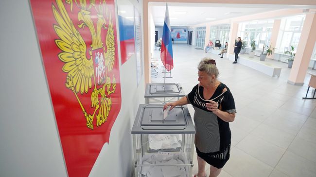 Женщина голосует на выборах 