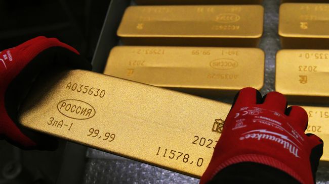 Сотрудник помещает на тележку готовый маркированный слиток золота
