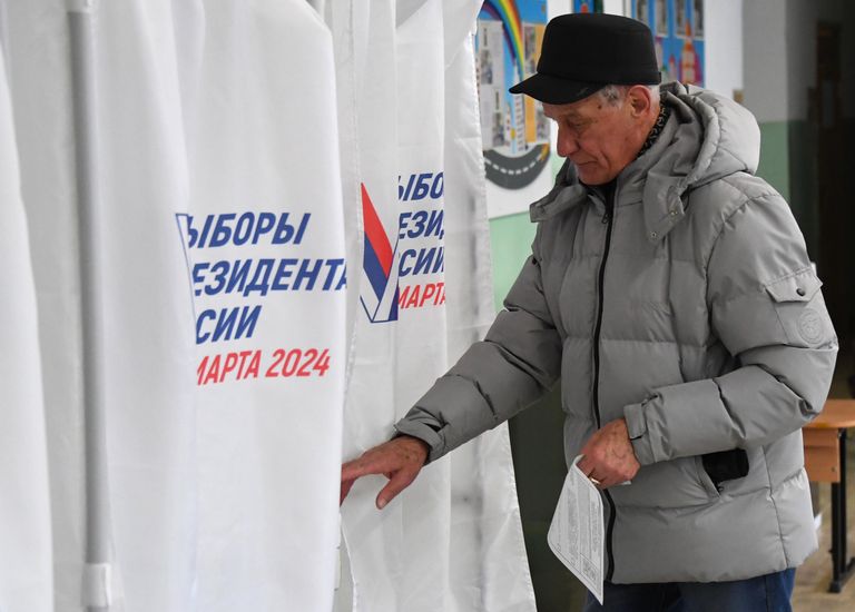 Мужчина голосует на выборах президента России на избирательном участке во Владивостоке Мужчина голосует на выборах президента России на избирательном участке во Владивостоке
