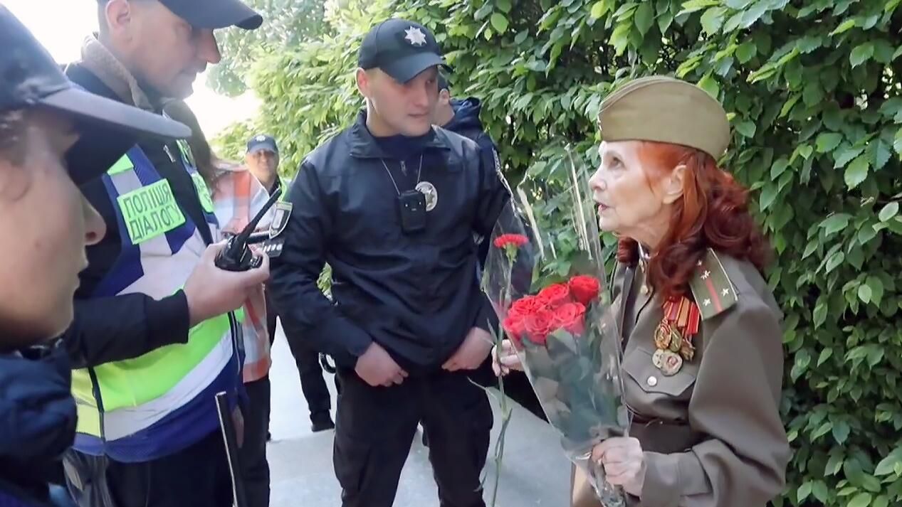 Сотрудники полиции Украины не пускают женщину возложить цветы к Вечному огню в Киеве. Кадр видео Сотрудники полиции Украины не пускают женщину возложить цветы к Вечному огню в Киеве. Кадр видео - РИА Новости, 1920, 09.05.2024