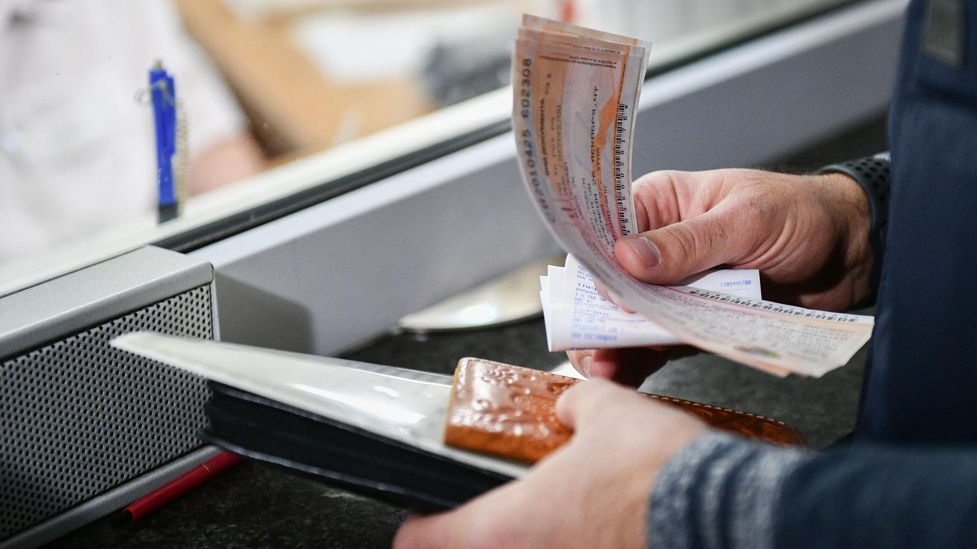 Билеты на пассажирский поезд в руках мужчины на железнодорожном вокзале Билеты на пассажирский поезд в руках мужчины на железнодорожном вокзале - РИА Новости, 1920, 19.07.2025