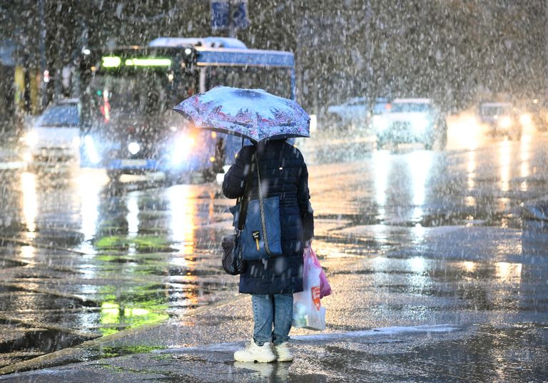 Женщина во время снегопада на одной из улиц Москвы Женщина во время снегопада на одной из улиц Москвы