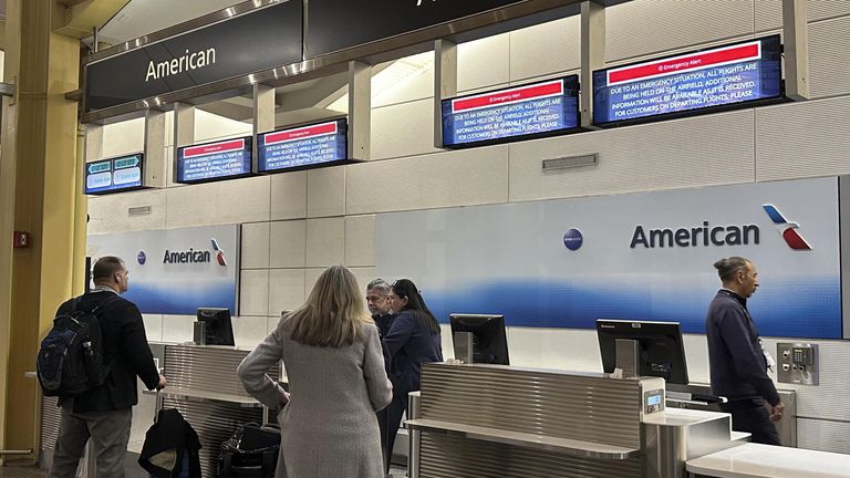 Над стойкой American Airlines в терминале Вашингтонского национального аэропорта имени Рональда Рейгана висят таблички с надписью Экстренное предупреждение Над стойкой American Airlines в терминале Вашингтонского национального аэропорта имени Рональда Рейгана висят таблички с надписью Экстренное предупреждение