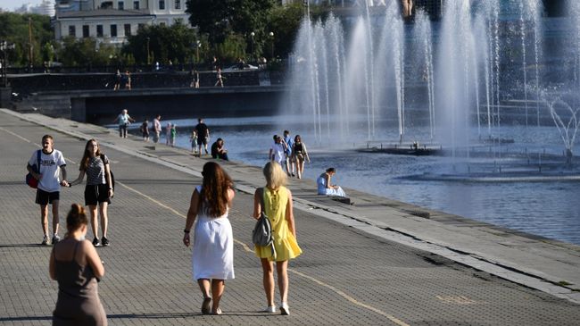 Люди гуляют у фонтана