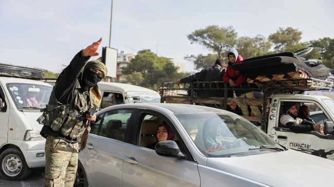 Сирийский военный направляет жителей, бегущих из районов Шейх-Максуд и Ашрафия после боестолкновений с курдами в Алеппо