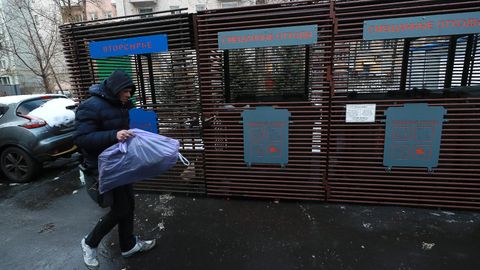 Мужчина несет мусор к контейнерам для раздельного сбора отходов в одном из дворов в Москве Мужчина несет мусор к контейнерам для раздельного сбора отходов в одном из дворов в Москве