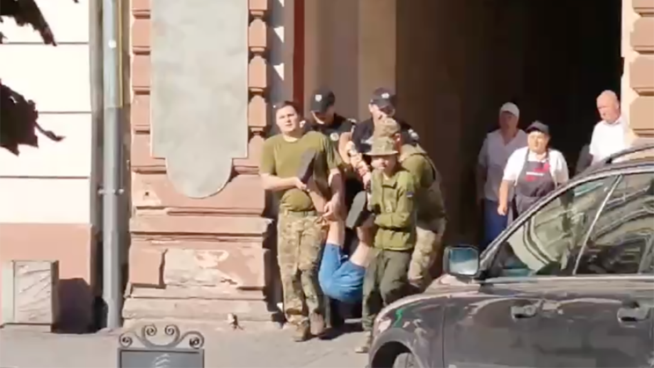 Сотрудники ТЦК вместе с полицейскими выносят со двора мужчину во Львове Сотрудники ТЦК вместе с полицейскими выносят со двора мужчину во Львове - РИА Новости, 1920, 23.08.2026