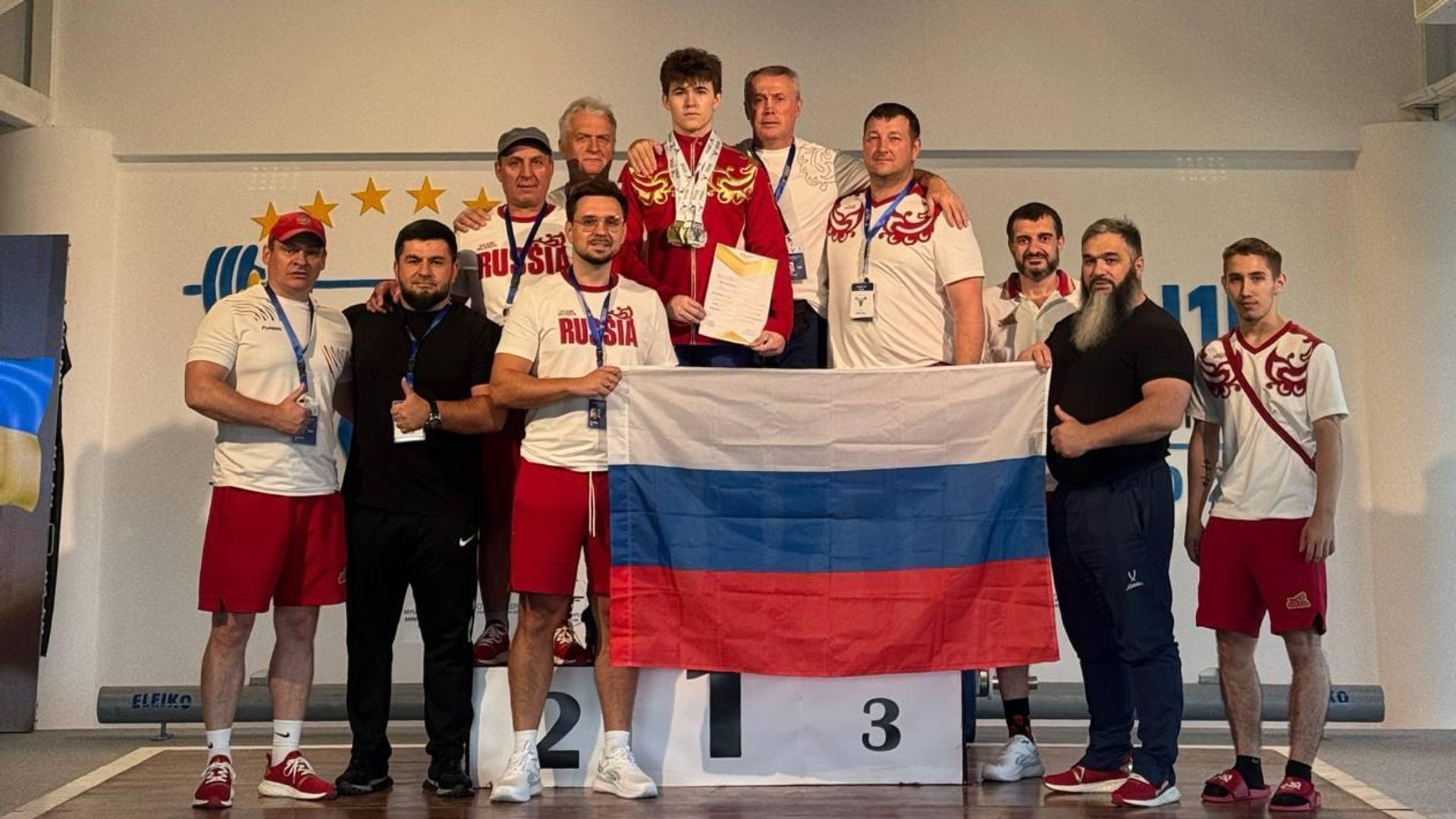 Арсений Курочкин с командой на чемпионате Европы по тяжелой атлетике в Косово Арсений Курочкин с командой на чемпионате Европы по тяжелой атлетике в Косово - РИА Новости, 1920, 25.08.2026
