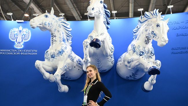 Девушка фотографируется на стенде Министерства культуры России на выставке в рамках Международного фестиваля молодежи в Екатеринбурге
