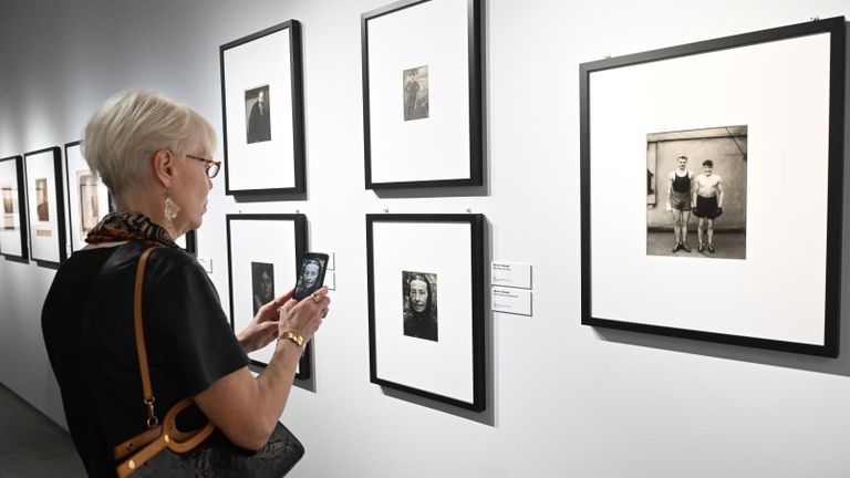 Посетитель на выставке Новаторы мировой фотографии в центре визуальной культуры Beton в Москве. Справа - работа фотографа Августа Зандера Боксеры.