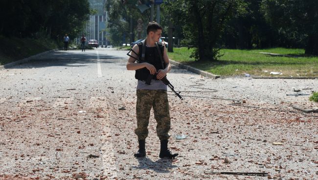 Ополченец около жилого дома в центре Донецка. Архивное фото Ополченец около жилого дома в центре Донецка. Архивное фото