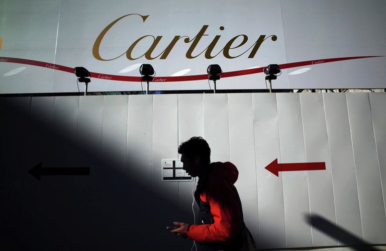 Прохожий на фоне рекламного баннера Cartier. Архивное фото