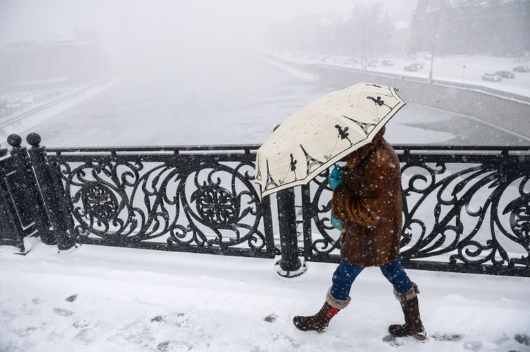 Прохожая на Патриаршем мосту в Москве во время снегопада Прохожая на Патриаршем мосту в Москве во время снегопада