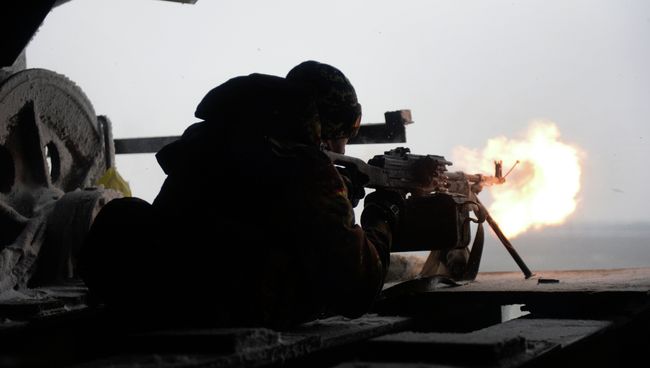 Боец украинского добровольческого батальона стреляет из автомата. 3 января 2015 Боец украинского добровольческого батальона стреляет из автомата. 3 января 2015